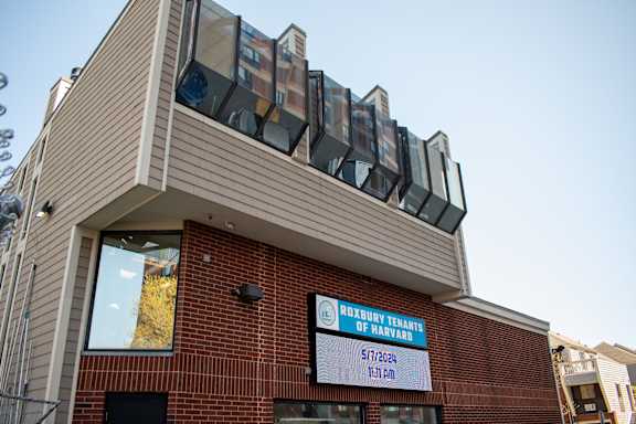 the front of a brick building with a sign for the county office of patient services