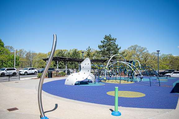 a playground with a slide and climbing equipment in a park