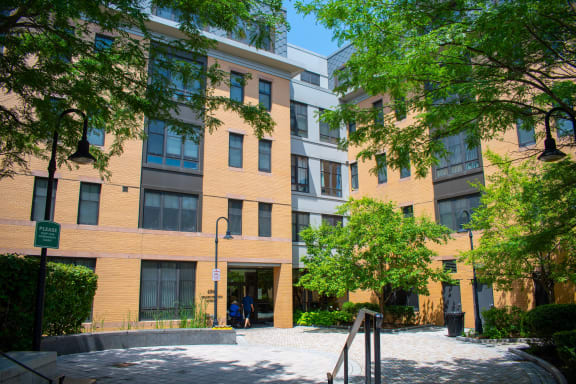 a large brick building with trees in front of it
