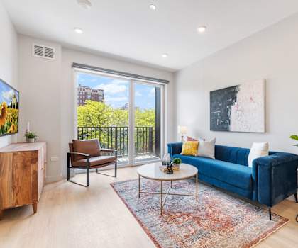 a living room with a blue couch and a large window