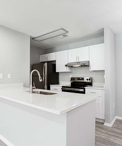 an empty kitchen with white cabinets and a white counter top at Keita 1875, College Park