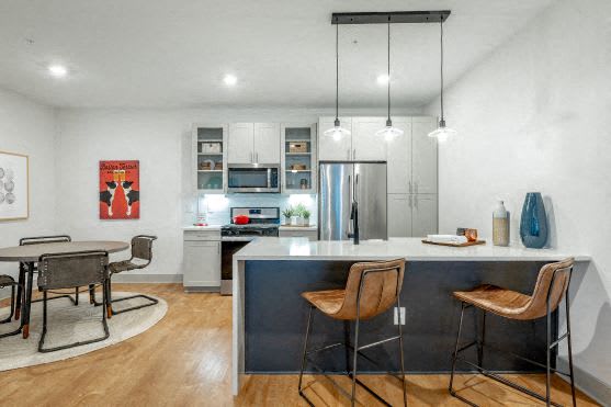 a kitchen and dining room with a table and chairs