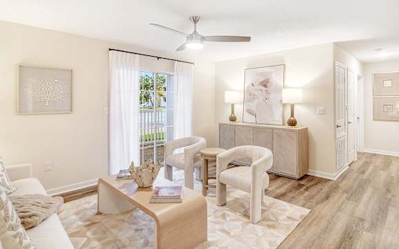 a living room with a couch and chairs and a table