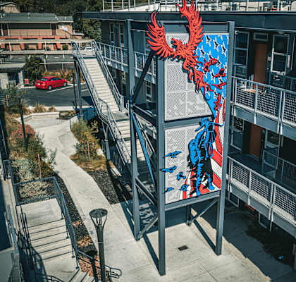 a large mural of a red and blue bird on the side of a building at ROCKY HILL VETERANS HOUSING, VACAVILLE, 95688