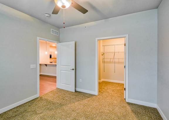 A blue and white townhouse with a front yard and a driveway.at Hawthorne Pointe, Bondurant, 50035