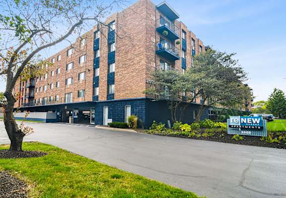 a large brick building with a sign in front of it  at ReNew Aurora, Aurora, Illinois