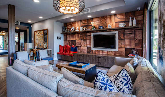 A living room with a grey couch and a wooden coffee table.