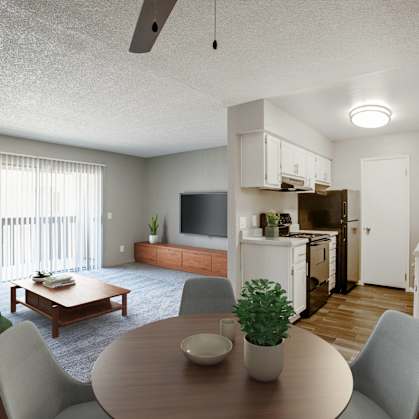 an open living room and kitchen with a table and chairs