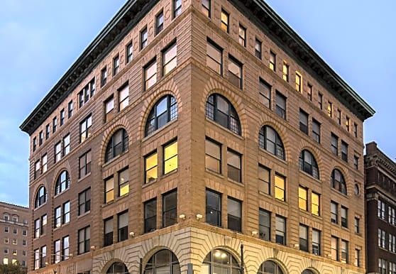 a tall brown building with lots of windows