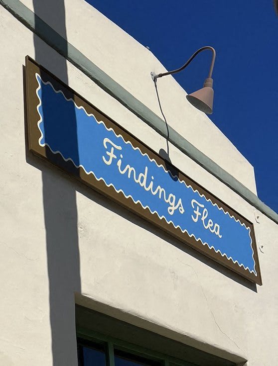 a blue and white sign on the side of a building