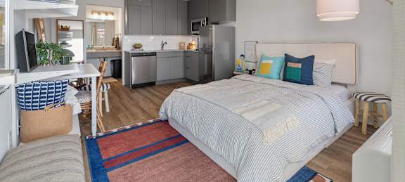 studio apartment bed desk and kitchen at The Teale Navy Yard, North Charleston, South Carolina