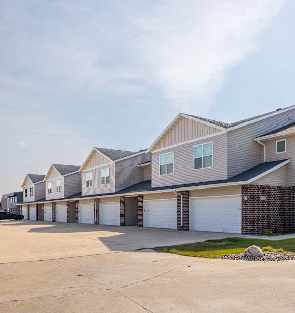 A row of houses with garages in front.