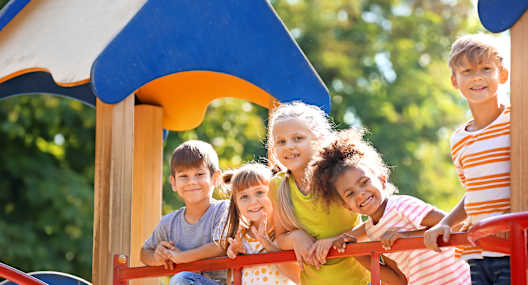 Children playing on a playground slide.