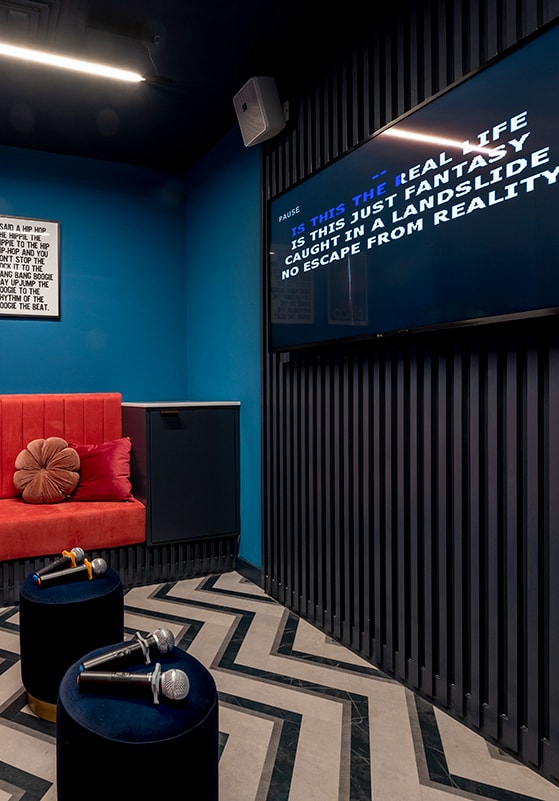 a living room with a red couch and a television