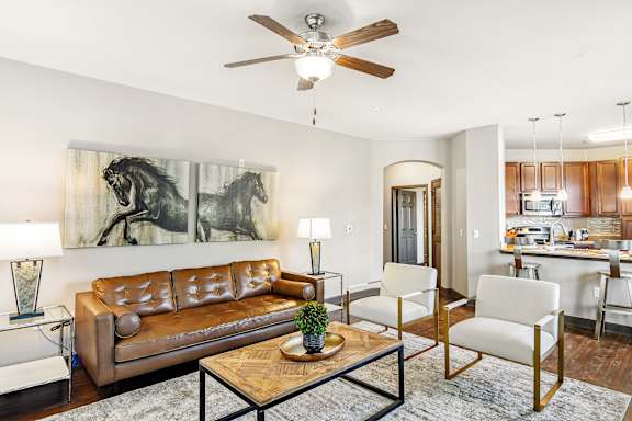 a kitchen with wood cabinets and stainless steel appliances  at Wellington Grande Apartment Homes, Longview, Texas