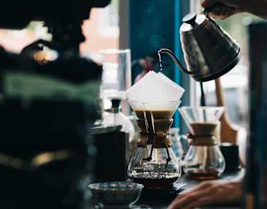 a person pouring coffee into a coffee maker