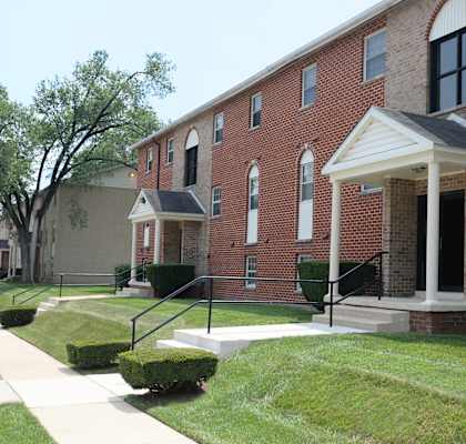 a large brick building with a porch