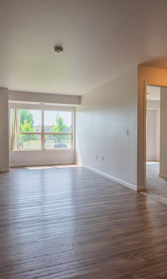 A room with wooden floors and white walls.