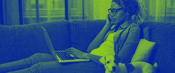 a woman sitting on a couch with a laptop