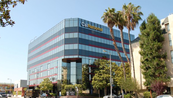 a large building with palm trees in front of it