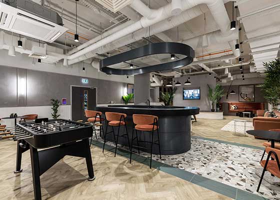 a large room with a pool table and a bar