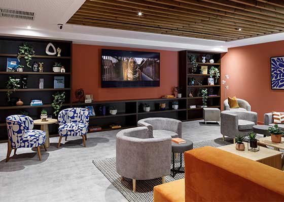a living room with couches and chairs and a tv