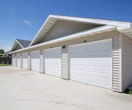 The exterior of the white and tan covered garages available to rent in Phoenix Ridge Apartments. 
