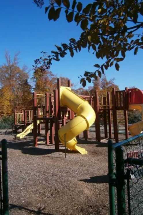 A playground with a yellow slide and a red slide.at The Village at England Run, Fredericksburg, Virginia