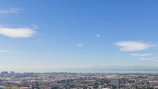 A cityscape with buildings and roads under a clear sky. at Hamilton Courtyard Apartments, Costa Mesa, 92627