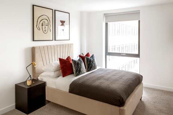 a bedroom with a bed and a large window