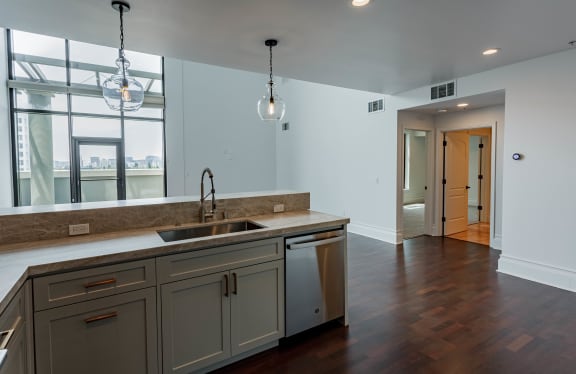 an empty kitchen with a sink and a large window at Vendome Place, California 95110