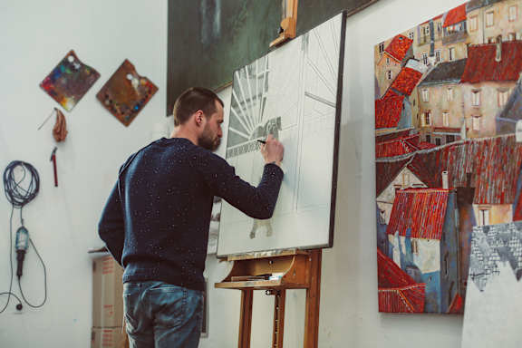A Man is Painting a Picture on a Canvas at The Rey Downtown Apartments, Arizona , 85003