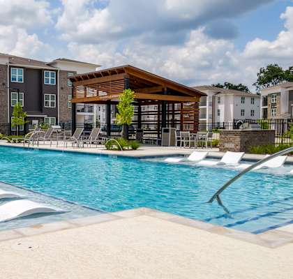 A large swimming pool with a slide in the middle of it.