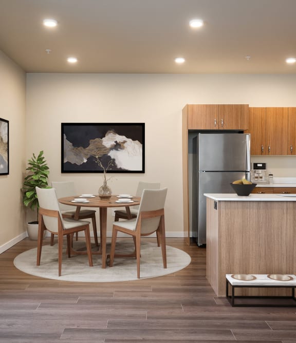 a kitchen and dining room with a table and chairs