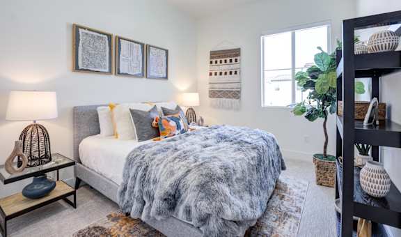a bedroom with a bed and a couch and a window