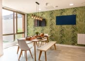 Thumbnail 2 of 8 - a dining room with a table and chairs and a wall mural of palm trees