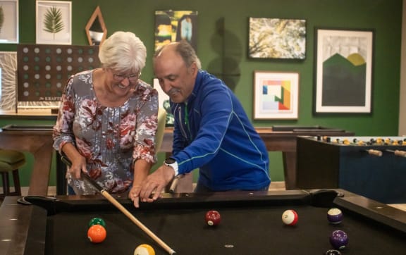 a man and woman playing a pool game on a pool table  at Vue at Bluestone, Duluth, MN, 55803