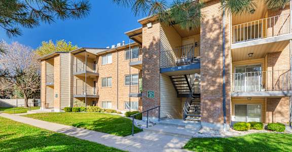 Apartment building with a green lawn in front.