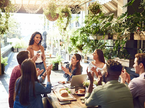 a group of people sitting around a table in a restaurant at Balfour 296 Apartments in Lilburn, Georgia, 30047