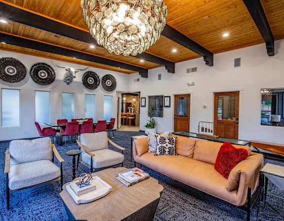 A living room with a couch, chairs, and a coffee table.