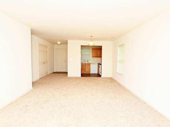 A kitchen with wooden cabinets and white appliances.