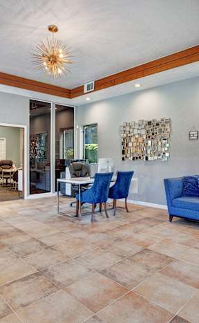 A living room with a blue couch and a wooden floor. at The Henley Apartments, Suisun City, CA, 94585