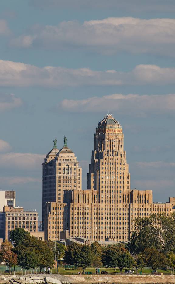 A city skyline with a mix of modern and older buildings.