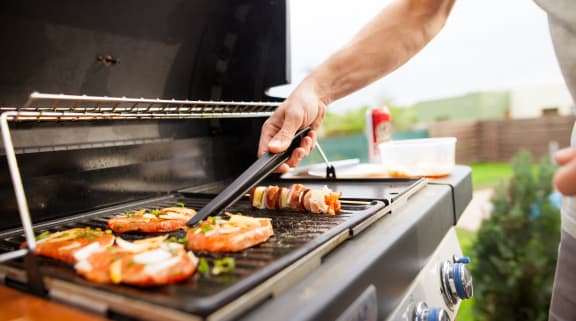 a man grilling food on a bbq at 2929 on Mayfair, Wauwatosa, WI, 53222