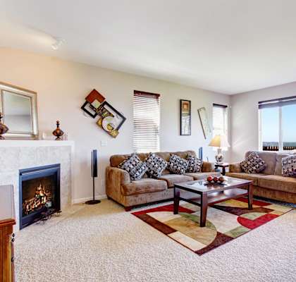 a living room with a fireplace and couches