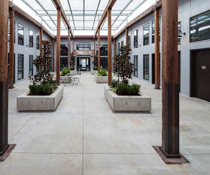 a courtyard with benches and trees in the middle of a building