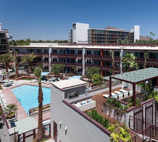 A resort with a pool and palm trees.