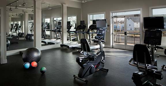 a gym with treadmills and other exercise equipment