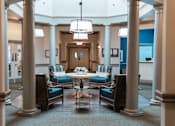 Thumbnail 2 of 5 - A room with a table surrounded by chairs and a chandelier hanging from the ceiling.