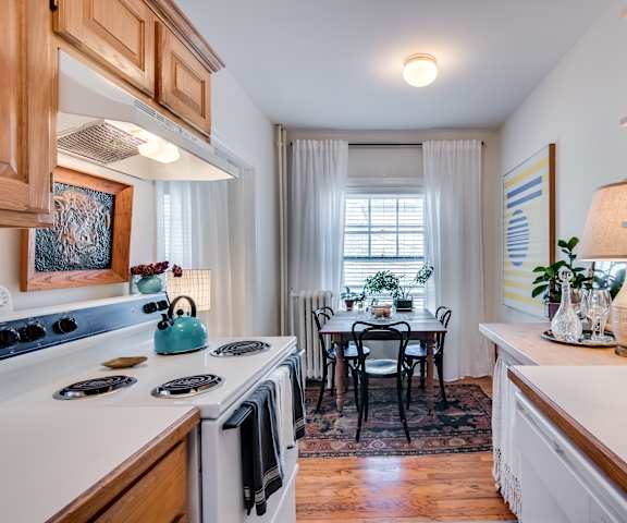 A kitchen with a table and chairs in the middle of the room.